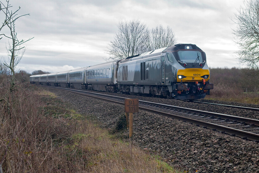 68011, CH 11.00 London Marylebone-Birmingham Moor Street (1R24, RT), Clattercote SP455490 
 The 11.00 Marylebone to Birmingham Moor Street Chiltern 'super train' climbs the steady rising gradient to the north of Banbury near the remains of Clatercote Priory which is now a rambling farm near the village of Claydon. The train could be heard for some distance before coming into sight with 68011 working hard shattering the peace of the Oxfordshire countryside! 
 Keywords: 68011 11.00 London Marylebone-Birmingham Moor Street 1R24 Clattercote SP455490 Chiltern Railways