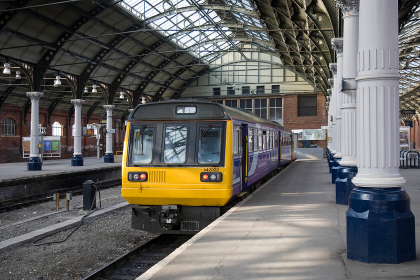 142022, stabled, Darlington station 
 142022 sits quietly at one of Darlingtons south facing bay platforms awaiting its next turn of duty. Whilst the south-facing platforms are still in use even if the centre two roads have been removed, the ones to the north of the station have been filled in now being part of the station car park following the closure of the routes to Barnard Castle (1964) and Richmond (1969). 
 Keywords: 142022 Darlington station Northern Pacer