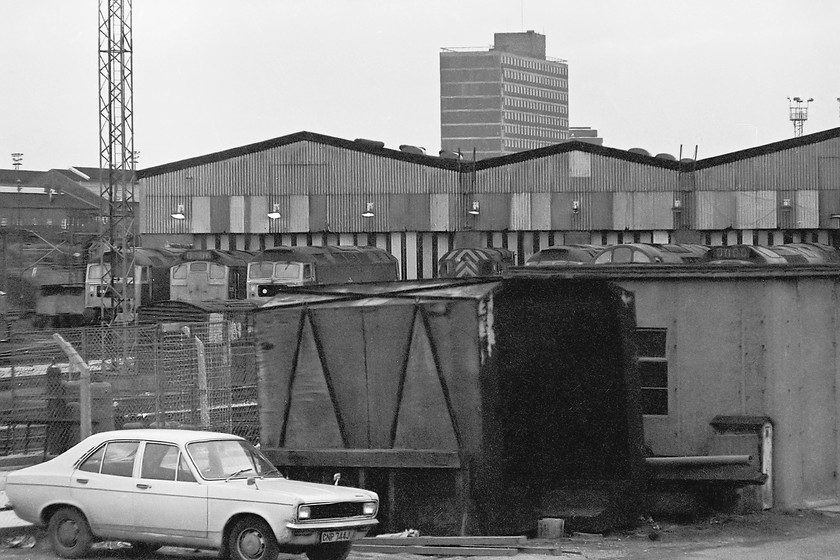 Classes 47, 24, 25, 40 & 08, on-shed, Crewe Diesel Depot 
 Passing Crewe DieselDepot sees various classes of locomotive outside the shed. It is likely that all the locomotives seen have now been withdrawn and cut-up, I suspect that a similar fate befell the 1970/71 Hillman Avenger parked in the foreground. Whilst its registration number can clearly be read, it does not appear on the DVLA's data base so I cannot say how many more years it had on the road from when this picture was taken. Looking at the state of the front wing around the headlight, I suspect that time on it would be called soon! 
 Keywords: Class 47 24 25 40 08 Crewe Diesel Depot