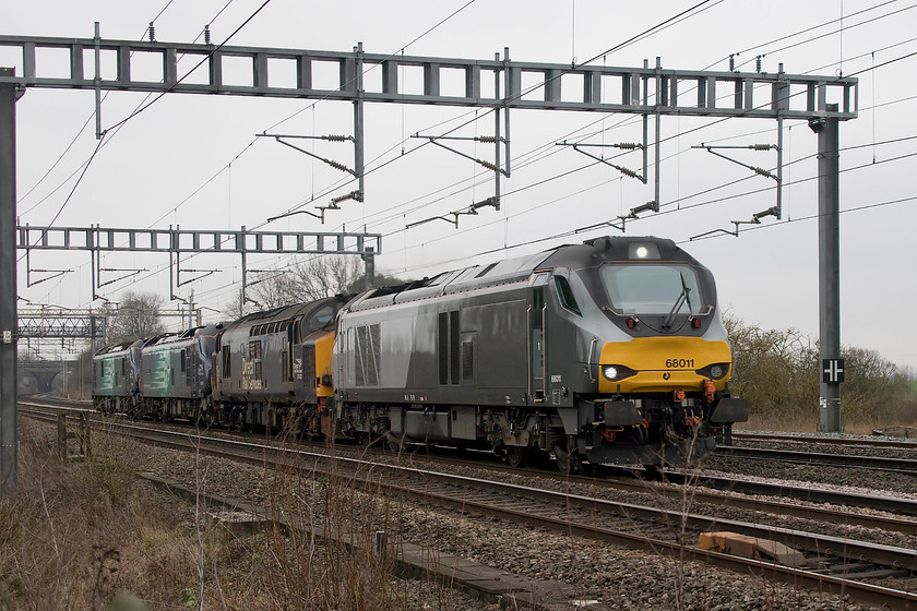 68011, 37423, 88008 & 88007, 09.35 Wembley-Crewe Gresty Bridge (0K68), Ashton Road bridge 
 This 0K68 light engine convoy had been flagged up on the internet since the morning with observations posted from Willesden and Wembley yards. 68011 leads 37423 'Spirit Of The Lakes', 88008 'Ariadne' and 88007 'Electra' past my recently cleared spot between Roade and Ashton. 
 Keywords: 68011 37423 88008 88007 09.35 Wembley-Crewe Gresty Bridge 0K68 Ashton Road bridge