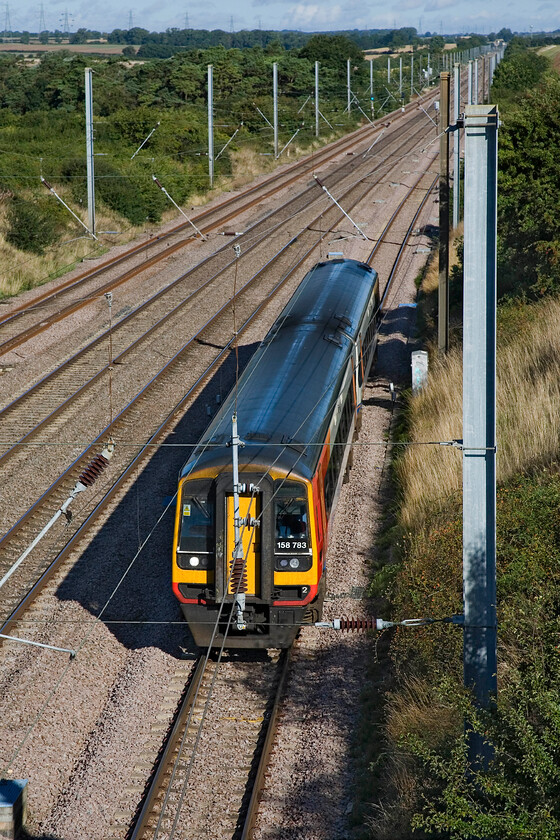 158783, EM 08.32 Nottingham-Norwich (1L04), Essendine TF042129 
 The perils of photographing trains on electrified routes! 158783 takes the up slow line at Essendine having descended Stoke bank working the 08.32 Nottingham to Norwich East Midlands service. I have included this image as a reminder to place the subject of a photograph better before pressing the shutter. 
 Keywords: 158783, EM 08.32 Nottingham-Norwich (1L04), Essendine TF042129