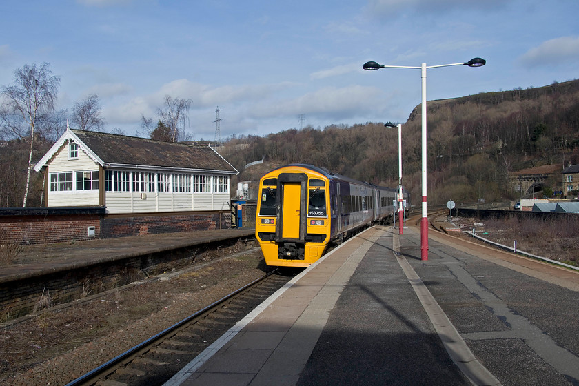 158755, NT 12.57 Manchester Victoria-Leeds (2E15, RT), Halifax station 
 158755 leaves Halifax station with the 12.57 Manchester Victoria to Leeds. It is about to cross the eleven arch Halifax viaduct and then plunge into the 0.6 mile long Beacon Hill tunnel. The grade II listed portal of the tunnel can be see in the background to the right. 
 Keywords: 158755 12.57 Manchester Victoria-Leeds 2E15 Halifax station