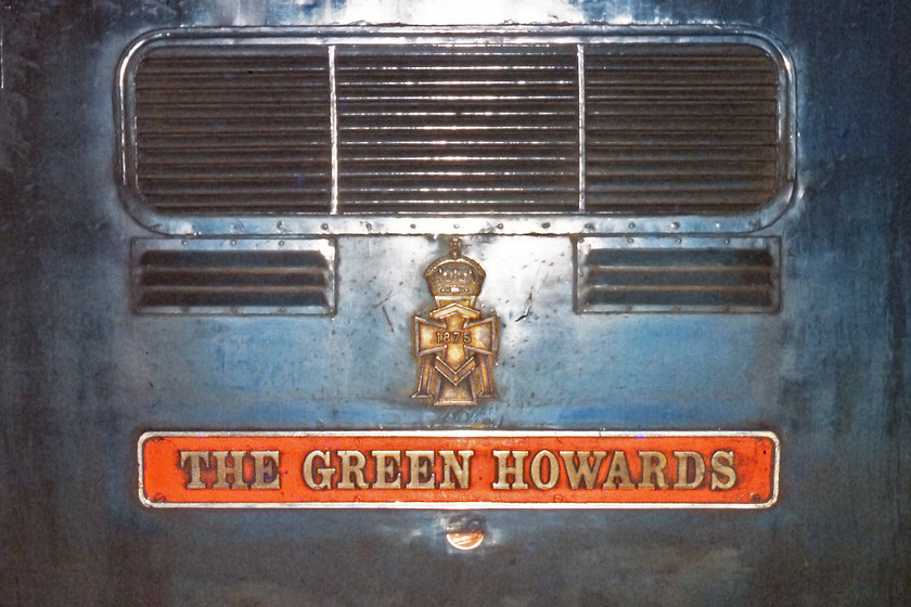 Nameplate, 55 008, 19.15 Aberdeen-London King's Cross (1E40), York station 
 The nameplate of 55008 'The Green Howards' is pictured at York leading the 19.15 Aberdeen to King's Cross using the flash on my Pentax ME Super camera. The Deltic was named at Darlington with ceremony, performed by Brigadier G.W.Edin on 30.09.63. Notice the sticker underneath the nameplate attached by some wag or other. Close examination reveals that it appears to be part of a No Smoking sticker, very apt on the side of a Deltic given its propensity to send clouds of exhaust into the sky especially until the engines were thoroughly warmed up. 
 Keywords: Nameplate 55 008 19.15 Aberdeen-London King's Cross 1E40 York station The Green Howards Deltic