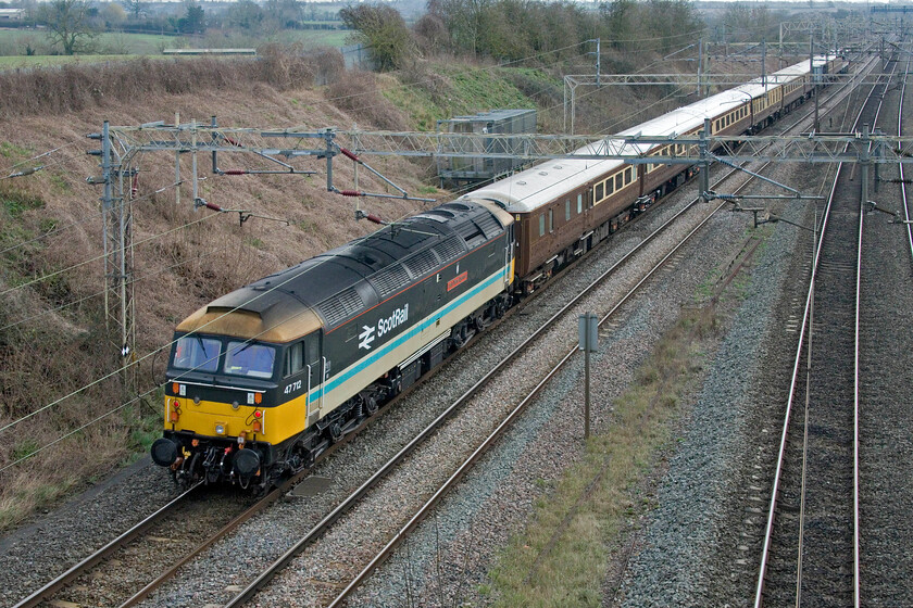 47712, 09.38 Liverpool Lime Street-Wembley Central (1Z90, 11E), Victoria bridge 
 The last time that I saw 47712 'Lady Dina Spencer' was less than a month ago, see.... https://www.ontheupfast.com/p/21936chg/30050159829/x47712-east-anglian-push-pull-07. Here it is dead in tow at the rear of the 1Z90 Liverpool Lime Street to Wembley Central footex passing Victoria bridge just south of Roade. It was conveying Liverpool supporters to Wembley for the 2023/24 EFL Cup match with Chelsea. They were to return home later in the evening happy after winning 1-0 in the last minute of extra time with the winning goal coming from captain Virgil van Dijk. 
 Keywords: 47712 09.38 Liverpool Lime Street-Wembley Central 1Z90 Victoria bridge Lady Diana Spencer