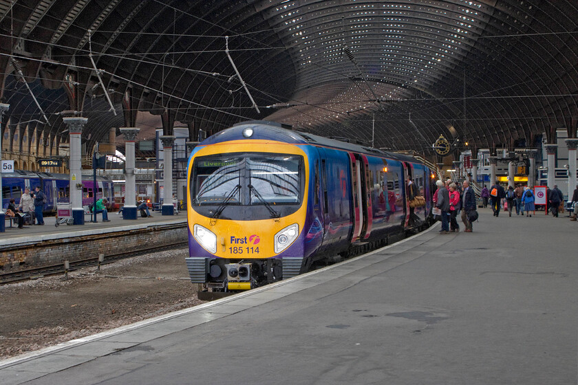 185114, TP 08.06 Newcastle-Liverpool Lime Street (1F64), York station 
 Under the grandiose roof of York station, TPE's 185114 pauses with the 08.06 Newcastle to Liverpool Lime Street. The sheer size of the magnificent curved roof is clear in this slightly zoomed photograph. 
 Keywords: 185114 08.06 Newcastle-Liverpool Lime Street 1F64 York station TPE Trans Pennine Express