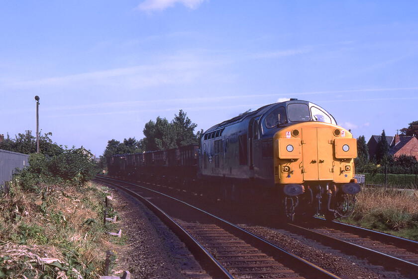 37017, up coal train, Park Road level crossing Spalding 
 Split headcode box 37017 leads a short up coal train towards Spalding having just passed Mill Green signal box that can be seen in the background. It is short (probably loss-making) freights such as this that are now almost completely absent from todays railway and sorely missed by the enthusiast and photographer alike. This particular working was probably a local trip working as, according to the Class 37.co.uk website the locomotive was on March depot both on this day and the previous day only leaving the area working a freight service to Temple Mills the following morning. I did not take a photograph of Mill Green signal box on this day as I took one on my last visit exactly a year previously, see. https://www.ontheupfast.com/p/21936chg/29682544204/mill-green-signal-box Incidentally, this locomotive is still with us but not currently in use. After ending its career wearing an EWS livery as 37503 it languished at Barrow Hill for many years but has now been moved to the Wensleydale Railway. 
 Keywords: 37017 up coal train Park Road level crossing Spalding