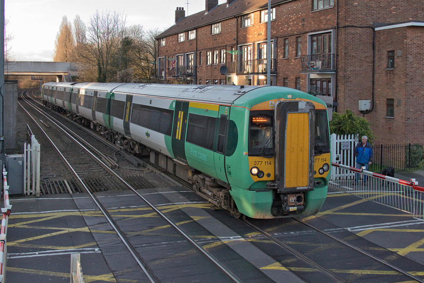 377114, SN 14.28 Southampton Central-Brighton (1N85, RT), Cosham station 
 Southern's Electrostar 377114 drifts into Cosham station over the level crossing with the 14.28 Southampton to Brighton service. There used to be a signal and crossing box just behind where the man in the blue jacket is standing. It was closed and demolished recently and I am a little disappointed as it was one of those that got away. 
 Keywords: 377114 14.28 Southampton Central-Brighton 1N85 Cosham station Southern Service Electrostar