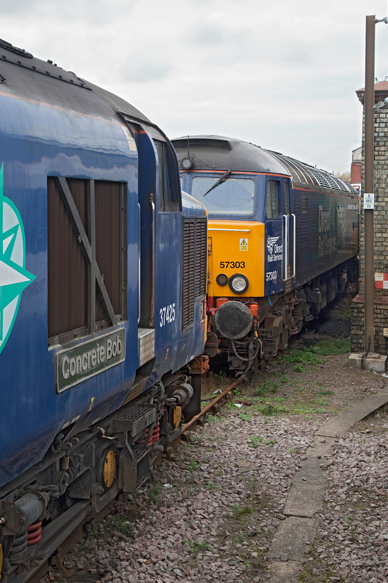 37425 & 57303, stabled, Norwich yard 
 37425 'Concrete Bob' and 57303 'Pride of Carlisle' sit stabled adjacent to Norwich station. They have been used at various times to operate the loco. hauled services for Greater Anglia operated by DRS. 
 Keywords: 37425 57303 Norwich yard