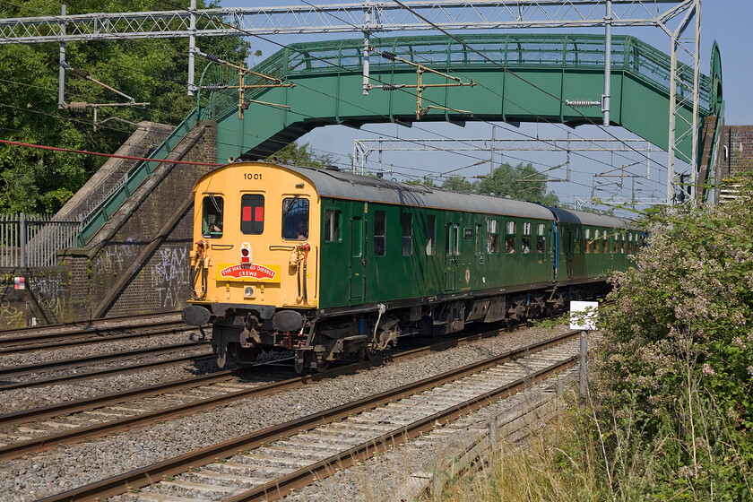 1001, outward leg of The Hastings Diesel's Crewe, 06.44 Hastings-Crewe (1Z06), Bradwell SP831391 
 1001 'Tunbridge Wells' is seen 'thumping' its way along the WCML; not something that you see every day! Looking superb in its green British Railways livery the Hastings gauge DEMU is passing Bradwell in Milton Keynes with the outward leg of the 1Z06 06.44 Hastings to Crewe charter. 
 Keywords: 1001, outward leg of The Hastings Diesel's Crewe, 06.44 Hastings-Crewe (1Z06), Bradwell SP831391Tunbridge Wells