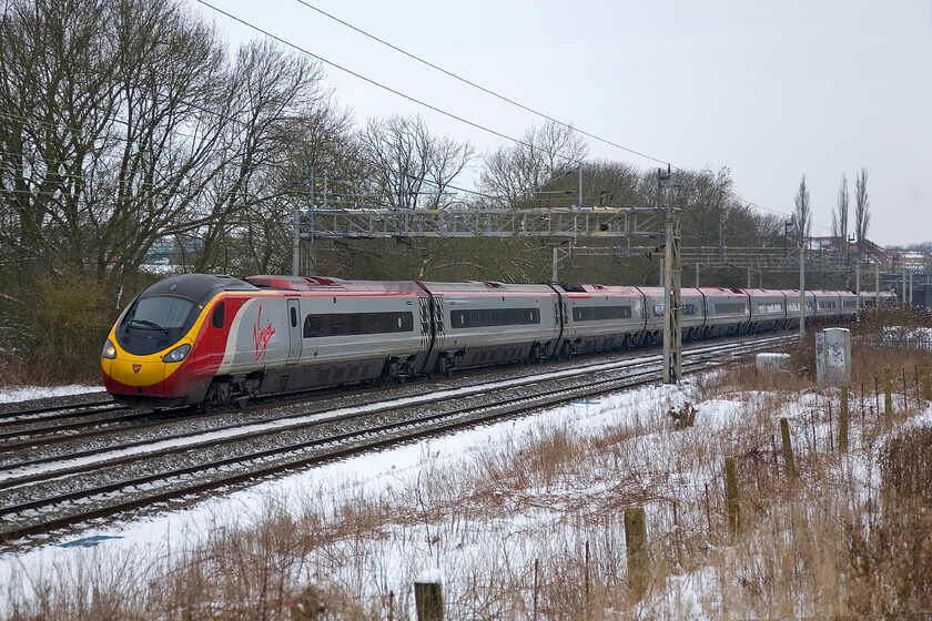 390124, VT 08.48 Liverpool Lime Street-London Euston, Roade 
 390124 'Virgin Venturer' passes Roade working Vrgin's 08.48 Liverpool to Euston service. It's hard to believe that the Pendolinos have been in service for ten years now, where has that time gone? 
 Keywords: Virgin Venturer 390124, VT 08.48 Liverpool Lime Street-London Euston, Roade Class 390 Pendolino