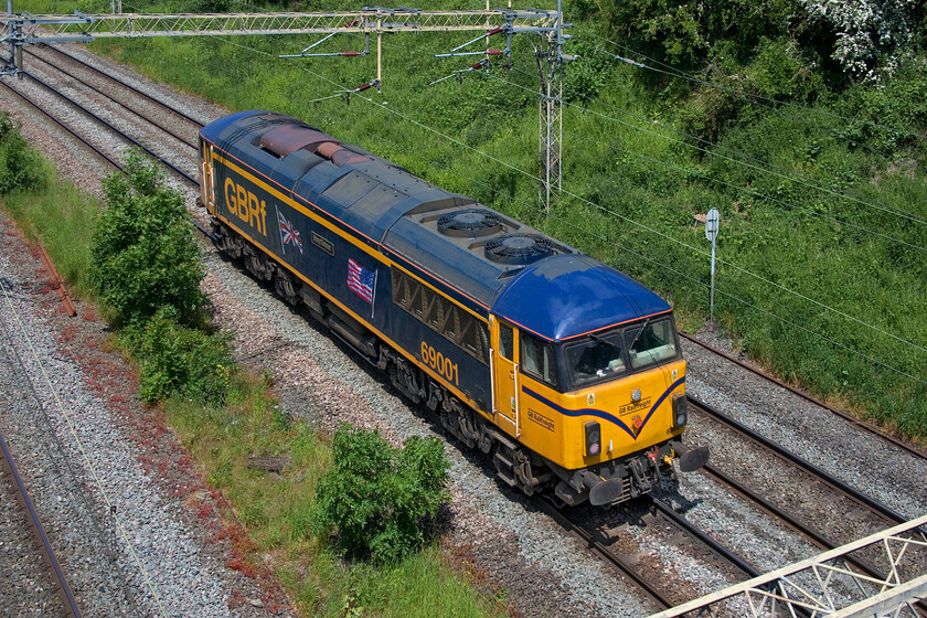 69001, 09.39 Tonbridge West Yard-Bescot Engineers (0Z78, RT), Victoria bridge 
 Complete with its speed whiskers as per the first generation DMUs from the 1960s 6900 'Mayflower' passes Victoria bridge between Roade and Ashton. The former 56031 entered service in 2021 but its path to operation has not been particularly smooth with various operational and technical issues cropping up that have needed rectification. On this sunny day and as it was a light engine I opted for this 'going away' vie of the locomotive running as the 0Z78 09.39 Tonbridge Yard to Bescot to make best use of the lighting. I really ould like to take some images of these re-purposed locomotives actually working a train and earning their keep but this is not particularly common, in our area on the WCML at least! 
 Keywords: 69001 09.39 Tonbridge West Yard-Bescot Engineers 0Z78 Victoria bridge GBRF Mayflower