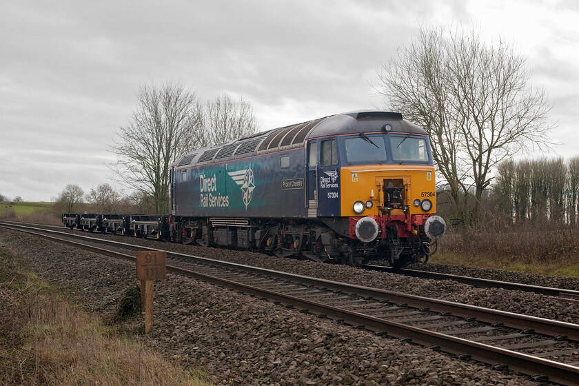 57304, 08.57 Eastleigh Arlington-Crewe Coal Sidings (6Z10, 10E), Clattercote SP455490 
 57304 'Pride of Cheshire' leads a short rake of four refurbished Freightliner flats past the hamlet of Clattercote (or Clatercotte to give its contemporary name). The train, running as 6Z10, left Eastleigh's Arlington facility at 08.57 heading for Crewe Coal Sidings that it reached a little early later in the afternoon. Notice the ninety-one and three-quarters milepost indicating the distance from London Paddington rather than Marylebone that would be expected. 
 Keywords: 57304 08.57 Eastleigh Arlington-Crewe Coal Sidings 6Z10 Clattercote SP455490 DRS Direct Rail Services Pride of Cheshire