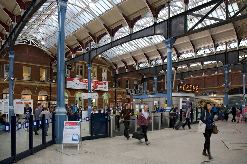 Concourse & gateline, Norwich station 
 The concourse at Norwich is just beginning to get a little busier at 16.19 (according to the station clock) with early departing commuters. I remember the concourse before the gateline was constructed and recall it being a much more open and pleasant place to be. I find it such a shame that access to the station has to be through these restrictive structures that do nothing for the aesthetics of the interior of the 1886 building. 
 Keywords: Concourse gateline Norwich station