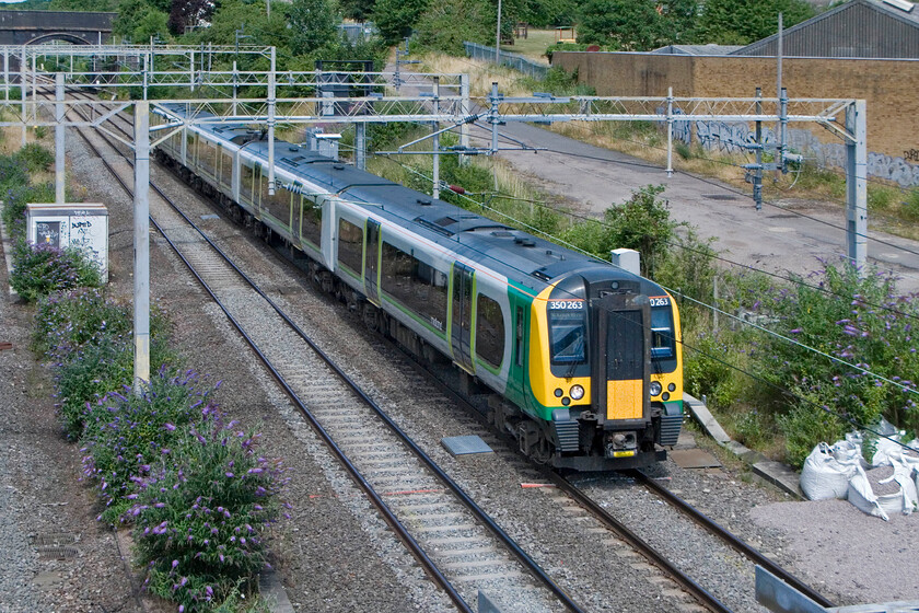 350263, LM 10.54 Birmingham New Street-London Euston, site of Roade station 
 London Midland's 350263 passes Roade working the 10.54 Birmingham New Street to Euston service. These reliable Desiros operate almost all London Midland services on this route with just a handful of ageing Class 321s supplementing during peak times. 
 Keywords: 350263 10.54 Birmingham New Street-London Euston site of Roade station London Midland Desiro