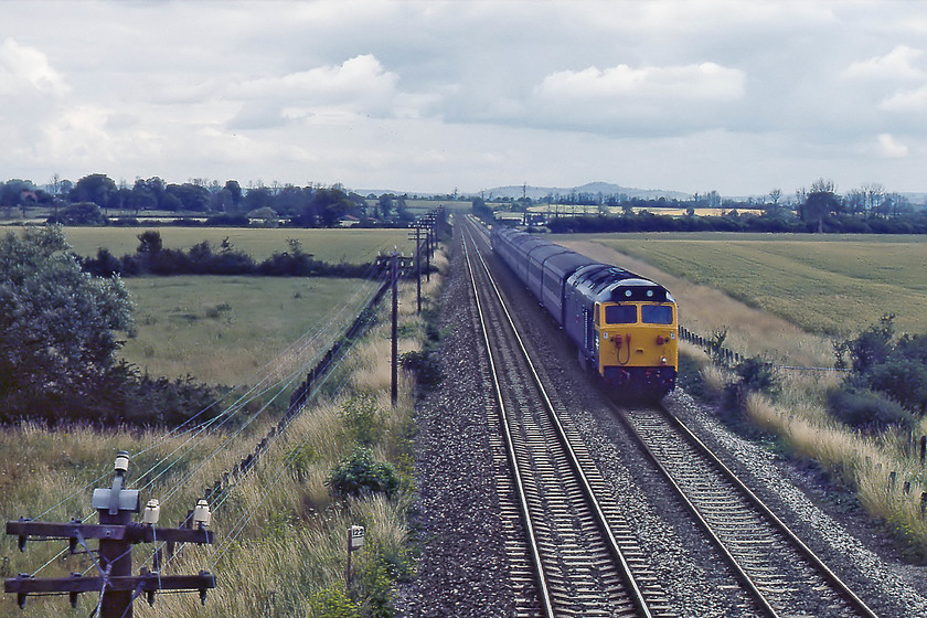 50008, 09.35 London Paddington-Pernzance, Charlton Adam ST538292 
 With just a hint of sun trying to break through the clouds at Charlton Mackrell, passing milepost 122 (from Paddington), with telegraph poles and wires for company, 50008 'Thunderer' heads west with the 09.35 London Paddington to Penzance working. However, this could be a misidentified locomotive. Close examination of the scan shows that the engine is named. But, records state that Thunderer did not receive its name until 1st September 1979, this is a month subsequent to the photograph. So, is this 50008 or not.help anybody? 
 Keywords: 50008 09.35 London Paddington-Pernzance Charlton Adam ST538292