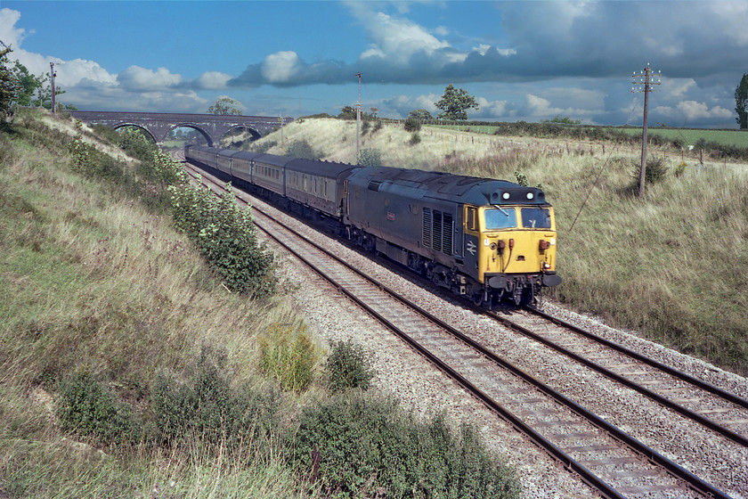 50019, unidentified down working, Easthill ST791477 
 50019 Ramillies heads westward past Easthill on the outskirts of Frome. It is leading an unidentified down express from London Paddington. Unfortunately, I am on the wrong side of the train for the sun and there is a bit of motion blur as the train was going at or close to the 90mph line speed. Even though I am using the Rollei camera its 1/500th sec. fastest shutter speed was not quite good enough to freeze the train. 
 Keywords: 50019 unidentified down working Easthill ST791477