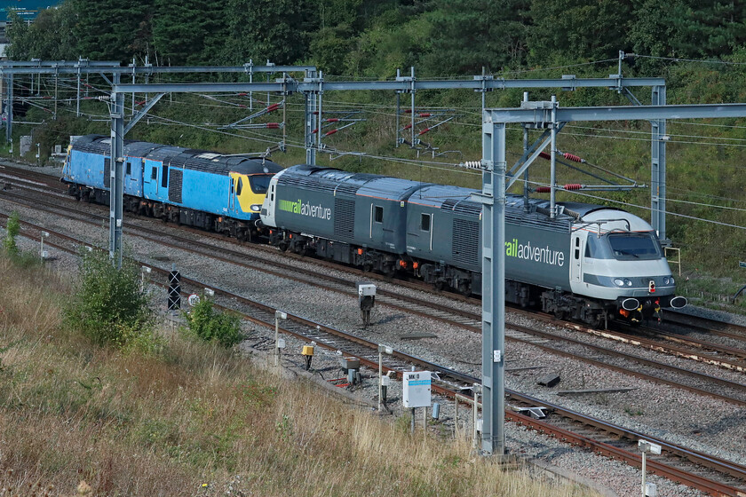 43423, 43467, 43484 & 43465, 13.26 Wembley Yard-Kidderminster SVR (0Z44, 3L), Loughton Redway bridge, Milton Keynes 
 The 0Z44 13.26 Wembley Yard to Kidderminster (SVR) passes just north of Milton Keynes station taken from one of the city's many Redway routes that crosses the line. The four power cars are (from the front) 43423, 43467, 43484 and 43465. The pair of liveries make for an interesting comparison with all four being used on various stock moves throughout the network. Of the three power cars seen here, the oldest is 43423 which as 43123 was a spare late set delivered to the East Coast route in May 1979. It was never formed into a 254 set as was 43122. The other three in this photograph were all part of the batch four sets delivered during the summer of 1982 (as 43167, 43184 and 43165) to operate on the NE/SW route ousting many locomotive-hauled services. Of course, all four were later converted in a stop-gap move to operate as ECML DVTs gaining their buffer beams whilst awaiting the late delivery of IC225s. 
 Keywords: 43423 43467 43484 43465 13.26 Wembley Yard-Kidderminster SVR 0Z44 Loughton Redway bridge, Milton Keynes HST Railadventure