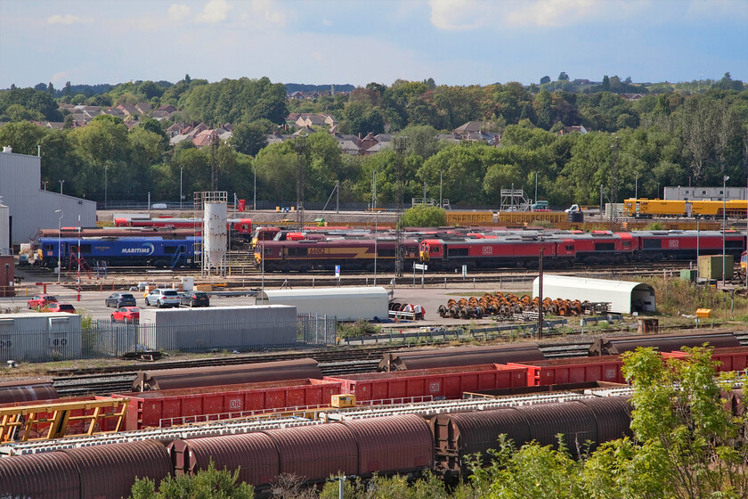 66162, 66069, 66012, 66117 & 66134, stabled, Toton depot 
 As is usually the case at Toton, there are many locomotives on view from the famous bank that affords a commanding view of the yard's operations. Without the requisite binoculars getting numbers is a bit of a challenge but using a combination of intense eyeballing combined with taking photographs and enlarging the digital image usually enables some identification. In this view, the locomotives identified from left to right appear to be 66162 'Maritime Intermodal Five', 66069, 66012, 66117 and 66134. Interestingly, all of these locomotives are not ones that I have many photographs of. A quick search of this site using the search button at https://www.ontheupfast.com/v/photos/21936chg/archive-files reveals just one other image recorded of each! 
 Keywords: 66162 Maritime Intermodal Five 66069 66012 66117 66134 stabled Toton depot