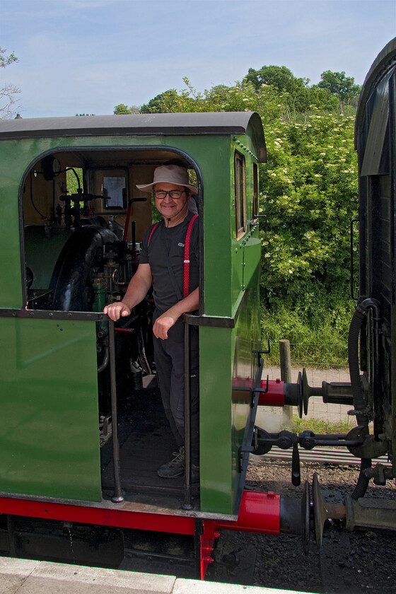 Me on the footplate, No. 4, 12.00 Pitsford return 
 Yours truly stands proudly n the footplate of Peckett 0-4-0 No. 4 (2104) after arrival back in Pitsford and Brampton station. The compact design of the Peckett, particularly in relation to its loading gauge is clear to see in this image with the relative height of the locomotive compared to the 4-Wheel CCT van to which it is attached. 
 Keywords: footplate No. 4 12.00 Pitsford return Peckett 2104 0-4-0 st