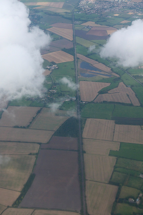 Chiltern Line, Ilmer, from flight VY0623 
 The last picture before we disappeared above the cloud shows the Chiltern Line between Princes Risborough and Haddenham that can be seen in the top right. The village of Ilmer is the settlement in the centre next to the line. 
 Keywords: Chiltern Line Ilmer from flight VY0623