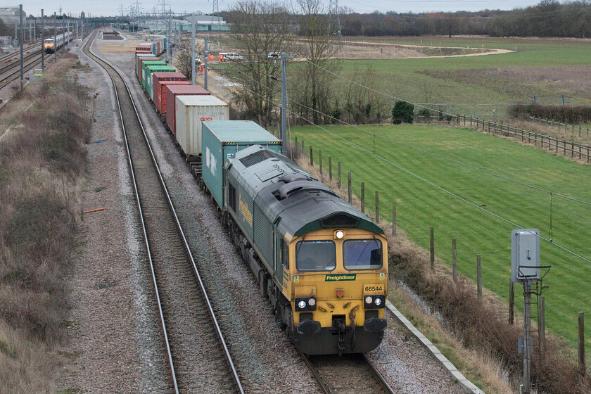 66544, 08.01 Felixstowe North-Crewe Basford Hall (4M81, 12E), Marholm TF154036 
 66544 accelerates up to line speed leading the 4M81 Felixstowe to Crewe Freightliner at Marholm just north of Peterborough. This 4M81 Freightliner has been known to travel via the WCML at times depending, it seems, on the availability of electric traction. Notice 91106 bearing down on the freight leading the 10.33 King's Cross to Leeds LNER service of which there is a better photograph coming next in this sequence, see...... https://www.ontheupfast.com/p/21936chg/30023305716/x9-91106-gr-10-33-london-king-s-cross 
 Keywords: 66544 08.01 Felixstowe North-Crewe Basford Hall 4M81 Marholm TF154036 Freightliner