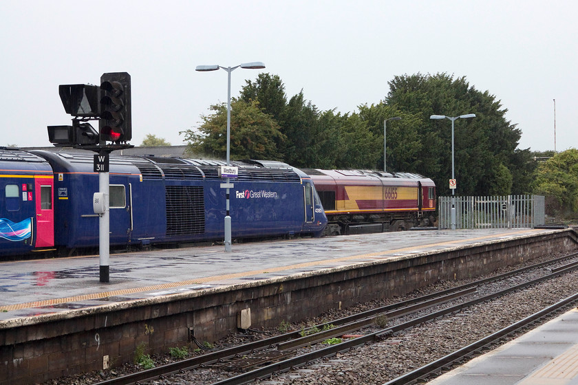 43183, GW 07.47 Plymouth-London Paddington (1A77) & 66155, engineer`s train, Westbury station 
 On arrival at a very wet and miserable Westbury station, 43183 is ready to leave with the 07.47 Plymouth to Paddington working. Behind it, 66155 waits at the head of an unidentified engineer's train. 
 Keywords: 43183 07.47 Plymouth-London Paddington 1A77 66155 engineer`s train Westbury station