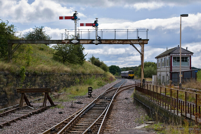 150118, NT 11.14 Leeds-Heysham Harbour (2H84), Hellifield station 
 150118 approaches Hellifield station working the 2H48 11.14Leeds to Heysham Harbour Northern service. The unit is about to pass the superb 1911 Midland signal box that controls all movements around and through the station. The gantry to the left is now a rarity on the network with this one now carrying just two arms. 
 Keywords: 150118 11.14 Leeds-Heysham Harbour 2H84 Hellifield station Northern