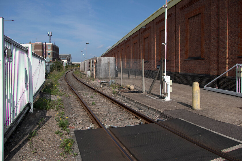 Access track, Wolverton works 
 The building to the right was once part of the Wolverton Works complex and now suffers from the ignominy of being the base for the spares' department of a white goods company! The line in the foreground is a long headshunt that permits trains to then reverse into the remains of the Works a short distance around the curve beyond the overbridge. 
 Keywords: Access track Wolverton works