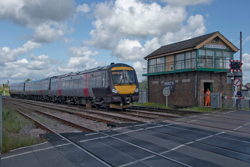 170618, XC 10.27 Stansted Airport-Birmingham New Street (1N15, 18L), March South Junction 
 With the sun having just gone behind an errant cloud Andy watches on from the other side (along with an S & T engineer) of the level crossing as the CrossCountry 10.27 Stansted Airport to Birmingham New Street service passes March South Junction signal box worked by 170618. Every time that I visit this location I wonder if the large Eastern Region enamel attached to the front of the box will still be there. As a trophy when the box eventually closes, it would be a fine prize but I feel that maybe it ought to be donated to the town council perhaps having been such an obvious visual marker for so many years. I first visited this box in 1981, see... https://www.ontheupfast.com/p/21936chg/30046908426/x29-march-south-junction-siganl-box 
 Keywords: 170618 10.27 Stansted Airport-Birmingham New Street 1N15 March South Junction CrossCounry Turbo XC