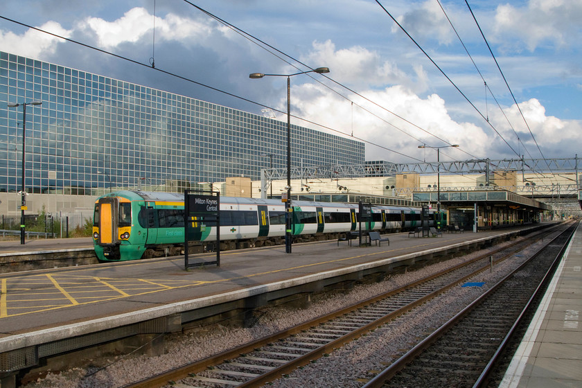 377202, SN 17.10. East Croydon-Milton Keynes (2M55), Milton Keynes station 
 Against a dramatic English summer sky, 377202 arrives at Milton Keynes with the terminating 17.10 Southern service from East Croydon. Also in the background is Milton Keynes' station block that houses the somewhat now inadequate concourse to which the footbridge joins. The station and its surrounds were designed by Stuart Mosscrop and it was opened to great fanfare in 1982. 
 Keywords: 377202 17.10. East Croydon-Milton Keynes 2M55 Milton Keynes station Southern Electrostar