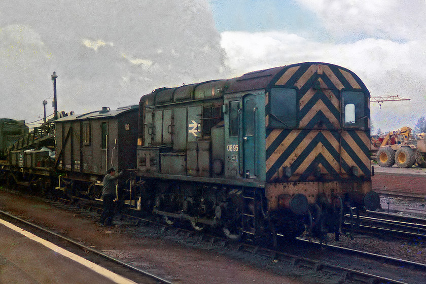 08951, shunting, Westbury station 
 08951 is captured shunting the breakdown train from Westbury station platform. Like so many Class 08s, it had a varied career over the years. This particular one was a West Country machine for many years going to Cardiff Canton after a spell here at Westbury. It moved north for a while and then ended up in private hands at Sheerness steelworks at the start of the new millenium.