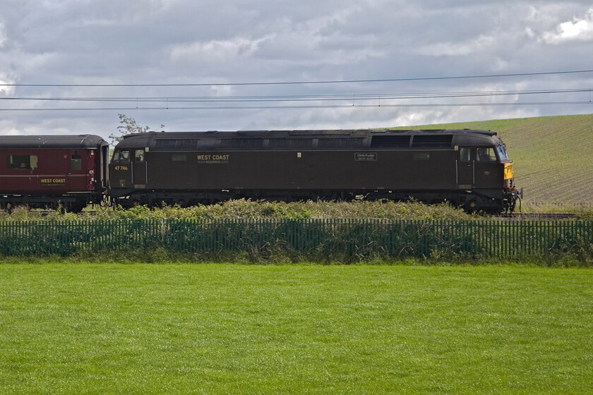 47746, outward leg of The Cumbrian Mountain Express, 06.30 London Euston-Carlisle (1Z86, 36L), Sedgwick SD514861 
 Totally backlit 47746 'Chris Fudge 29.7.70-22.6.10' brings up the rear of the 1Z86 06.30 London Euston to Carlisle Cumbrian Mountain Express charter. Whilst the Class 47 was under power and assisting with the assault of Shap it was Bulleid 34067 'Tangmere' doing most of the work at the front. This dark broadside view, taken near Sedgwick near Kendal, is in lieu of what would have been a more successful shot from the fields on the other side of the line. 
 Keywords: 47746 The Cumbrian Mountain Express 06.30 London Euston-Carlisle 1Z86 Sedgwick SD514861 Chris Fudge 29.7.70-22.6.10