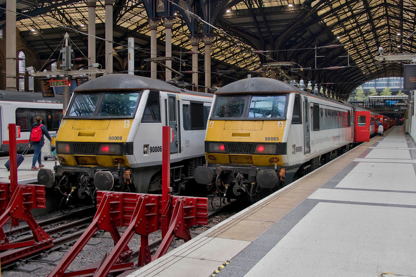 90006, GA 13.30 London Liverpool Street-Norwich (1P32, RT) & 90005, GA 14.00 London Liverpool Street-Norwich (1P34, 1L) London Liverpool Street station 
 A scene at London Liverpool Street's station that has been a familiar one for a number of years now as two class 90s sit on the blocks. To the left, 90006 will soon leave with the 13.30 to Norwich. Next to it, 90005 'Vice-Admiral Lord Nelson' will leave a little later with the 14.00 service. Time is about to be called on these 1980s locomotives and the slam-door stock on this route with the imminent introduction of the class 745 Stadler FLIRT EMUs. Whilst the class 90s will probably find other work, the stock will go to the scrap man. Notice in the background, next to the passenger information screens, the ex NSE 'click clack' clock still keeping good time. This particular example, which could be up to thirty-six years old, still retains its distinctive NSE red, blue and grey slash at the bottom of the case. There are fewer and fewer of these clocks still in use now, there is, in fact, a website dedicated to them! 
 Keywords: 90006 13.30 London Liverpool Street-Norwich 1P32 90005 14.00 London Liverpool Street-Norwich 1P34 London Liverpool Street station