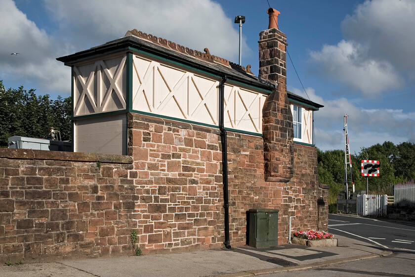 Askam signal box, (Furness, 1890) 
 Still retaining its chimney stack and pot Askham signal box is seen from the rear viewed from the station car park. It is a typical Furness Type 4 box containing a 1945 LMS lever frame. I is Grade II listed by Historic England with them siting its interesting design being partially built into the station's retaining wall and with the back wall being at an angle to give it more structural support. Unfortunately, Andy and I did not have much time to hang about this station as we still had to get to Lancaster to check in to our hotel and get out for a curry! 
 Keywords: Askam signal box Furness 1890