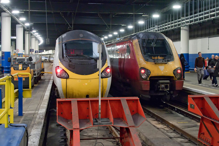 221112, VT 07.55 Holyhead-London Euston (1A20, 5L) & 390044, VT 12.00 London Euston-Manchester Piccadilly (1H23, 1L), London Euston station 
 Having arrived at London Euston, I turned the camera back to the buffers at platform one to capture the scene inside the dark and dingey station. We travelled down from Milton Keynes on 221112 'Ferdinand Magellan' that had formed the 07.55 from Holyhead. It pulled in next to 390044 that was at platform two that will soon work the 12.00 to Manchester Piccadilly. 
 Keywords: 221112 07.55 Holyhead-London Euston 1A20 390044 12.00 London Euston-Manchester Piccadilly 1H23 London Euston station Avanti West Coast Pendolino Voyager