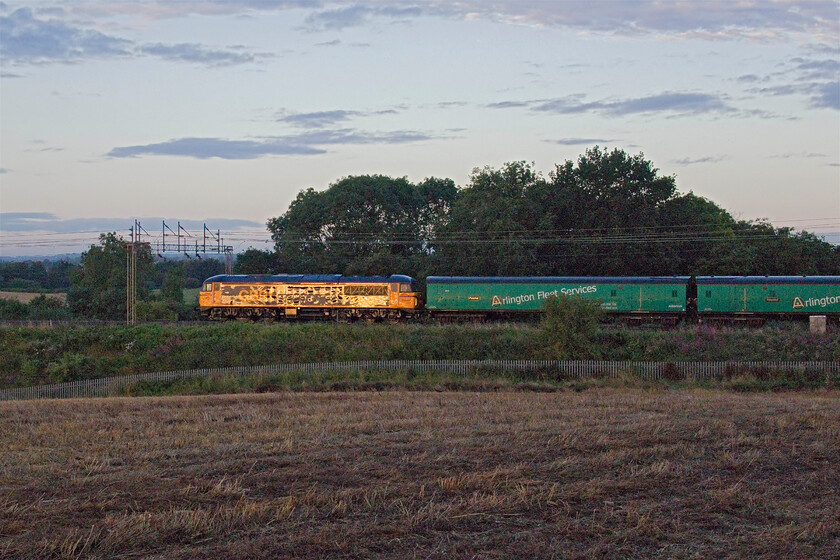 69008, 04.26 Wembley Yard-Widness Transport Tech (5Q69, 73L), between Roade & Ashton 
 The rear of the 04.26 Wembley Yard to Widness Transport Tech. passes between Roade and Ashton in Northamptonshire at a very slow pace and on the down fast but it was not even six in the morning so there was much other traffic about. Out of sight in front of the barrier coaches was South West Trains' 450253 heading north for attention at Alstom's Widness facility. To date, this is probably the most unusual working that I have photographed this year; we'll see what the remaining five months will bring! 
 Keywords: 69008 04.26 Wembley Yard-Widness Transport Tech 5Q69 between Roade & Ashton