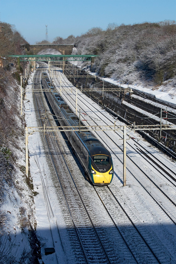 390006, VT 08.47 Liverpool Lime Street-London Euston (1A15, 12L), Roade cutting 
 Under a brilliant blue sky 390006 'Rethink Mental Illness' works the 08.47 Liverpool to Euston 1A15 Avanti West Coast service. Despite the sun being out after yesterday's snowfall the temperature was still below freezing here in Roade cutting. 
 Keywords: Rethink Mental Illness 390006 08.47 Liverpool Lime Street-London Euston 1A15 Roade cutting Avanti West Coast Pendolino