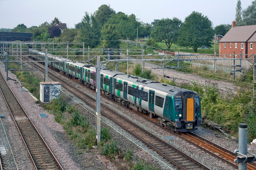 350374 & 350122, LN 17.05 Northampton-London Euston (2N16, RT), site of Roade station 
 The 17.05 Northampton to London Euston London Northwestern service passes the site of Roade's former station worked by Desiros 350374 and 350122. With so many variants of their livery adorning their trains, it makes a change to see a pair of Desros matching each other! 
 Keywords: 350374 350122 17.05 Northampton-London Euston 2N16 site of Roade station London Northwestern Desiro