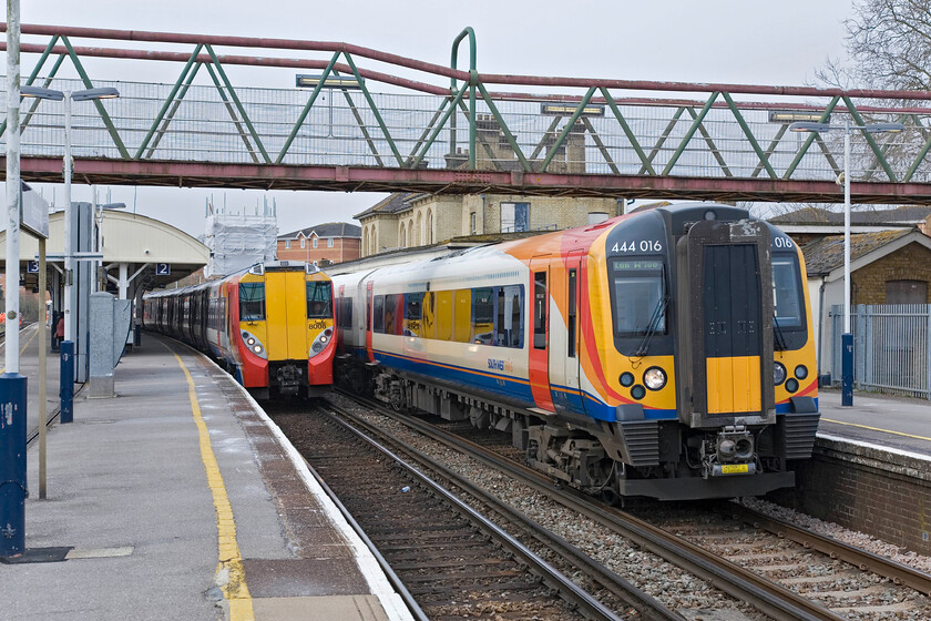 458008, SW 09.23 Ascot-Guildford & 444016, SW 10.14 Alton-London Waterloo, Aldershot station 
 As 458008 waits at Aldershot, with the driver having changed ends, working the 09.23 Ascot to Guildford service as 444016 leaves working the 10.14 Alton to Waterloo service. Aldershot is a busy commuter/stockbroker belt station with fast and regular services to Waterloo that is sometimes stymied by its three platforms with trains being stabled and reversed at the next station to the west Farnham. 
 Keywords: 458008 09.23 Ascot-Guildford 444016 10.14 Alton-London Waterloo Aldershot station South West Trains