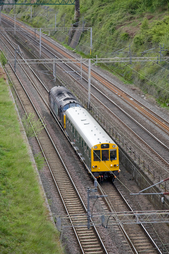 975025 Caroline & 37402, 08.05 Willesden Brent-Derby RTC (5Z02), Roade cutting 
 The purpose of my morning trip to Roade cutting was to capture the passage of the 5Z02 Willesden to Derby move. Here, DRS's 37402 propels 'Caroline', numbered 975025, through the cutting. 'Caroline' was originally built in 1958 at Eastleigh Works as type AZA trailer restaurant buffet car (trb) numbered S60755, intended for use in Class 203 diesel-electric multiple-unit No. 1036. However, it saw little use and was converted for other uses in 1964, including carrying Pope John Paul II during his visit to the UK in 1982. 
 Keywords: 975025 Caroline 37402, 08.05 Willesden Brent-Derby RTC 5Z02 Roade cutting