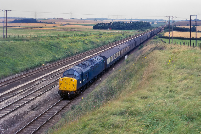 40101, up parcels working, Essendine TF043129 
 40101 takes the up slow line past Essendine working an unidentified up parcels train. The Class 40 motherlist site that contains a huge amount of information about the workings of this class have no information on what 40101 was working so if anybody has any information as what this train could have been please get in contact with me. It is so niticeable to see how 'open' the the scene is at Essendene, and the rest of the ECML for that matter with in these pre-electrification days! By way of a comparison, please see......https://www.ontheupfast.com/p/21936chg/26500879204/x43311-0 that shows the scene nealy forty years later. 
 Keywords: 40101 up parcels working Essendine TF043129