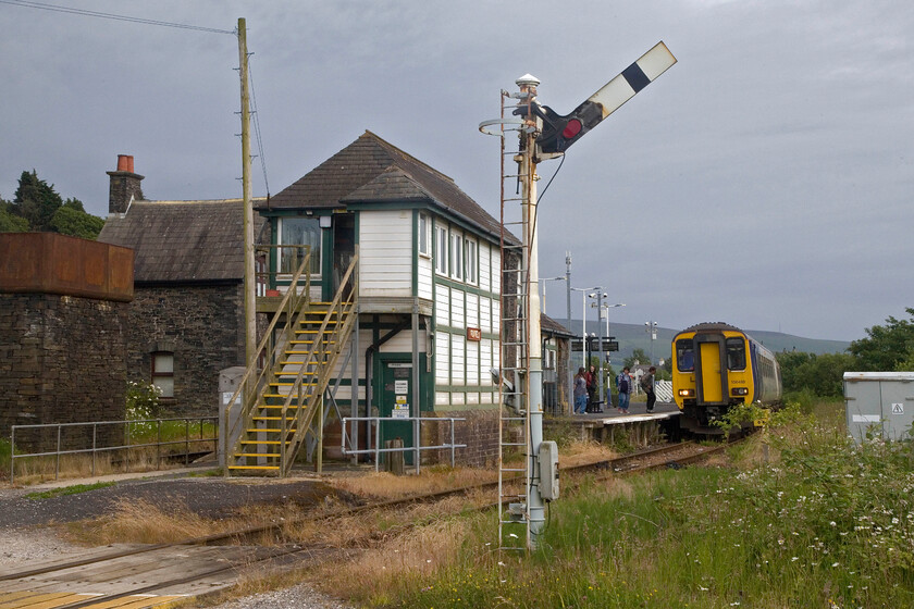 156488, NT 16.01 Lancaster-Carlisle (2C37, 21L), Foxfield station 
 I have visited Foxfield station a number of times over the years and love the rural and remote feel of the station despite that the busy A595 passes close to the station. The station was once a junction where the branch to Coniston diverged that was closed in 1958 to passengers with full closure coming in 1962. I have stood in this spot before to try and replicate my 1979 photograph taken of a DMU but unfortunately have not got the positioning quite right, see.... https://www.ontheupfast.com/p/21936chg/26718012404/m56250-m50947-14-40-barrow-furness In this view, 156488 is coming to a halt at the station working the 16.01 Lancaster to Carlisle and is drawing level with the superb 1879 Furness signal box. 
 Keywords: 156488 16.01 Lancaster-Carlisle 2C37 Foxfield station Northern