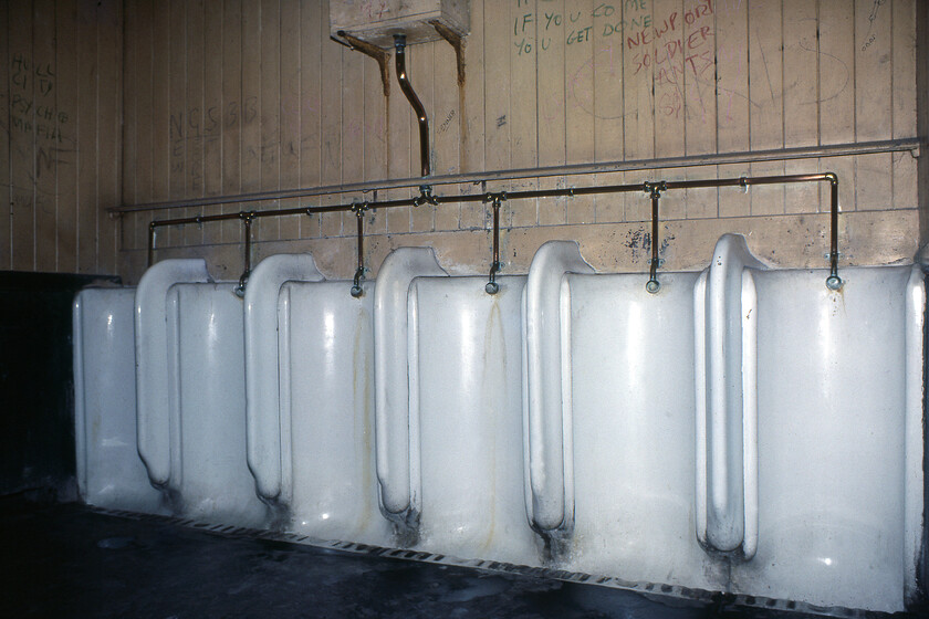 Urinal, New Holland Pier 
 Despite the generally decrepit condition of New Holland Pier station the gentlemens' urinal was actually quite well kept with the porcelain clean and the copper pipework polshed. However, even back in 1981 the vandals still did their worst to spoil the toilet walls; nothing changes! 
 Keywords: Urinal New Holland Pier