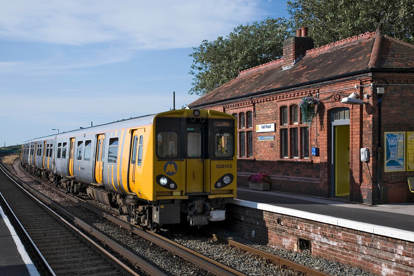 508143, ME 17.28 Southport-Hunts Cross, Hall Road station 
 Hall Road station is located at the very northern edge of the greater Liverpool urban area opening in 1874. The initial request to the Lancashire and Yorkshire Railway for a station here was refused but they agreed to one after a local merchant agreed to build five properties; how different to today's protocol for new station openings! 507143 arrives with the 17.28 Southport to Hunts Cross service. 
 Keywords: 508143 17.28 Southport-Hunts Cross Hall Road station Merseyrail