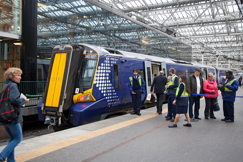 380107, SR 18.14 Edinburgh Waverley-North Berwick (2Y02), Edinburgh Waverley station 
 This was a picture that caused quite a rumpus! The female member of ScotRail staff, who was undertaking revenue protection duties, took great offence to me taking a picture of her. Just after I took this picture she stormed over to me demanding that I delete it, I refused and apologised if I caused any offence and stated that it was not of just her but the whole scene. She radioed through to somebody but nobody arrived to escort me from the station! 380107 will soon work the 18.14 to North Brewick 
 Keywords: 380107 18.14 Edinburgh Waverley-North Berwick 2Y02 Edinburgh Waverley station