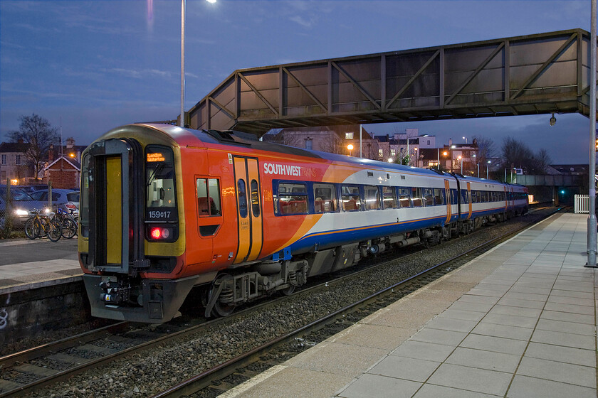 159017, SW 15.51 Bristol Temple Meads-London Waterloo (1O60), Trowbridge station 
 It is virtually dark by the time that Andy and I reach Trowbridge station in my just acquired Saab 93 sports wagon (or estate as it is known by anybody else!). South West Trains' 159017 has just arrived working the 1O60 15.51 Bristol Temple Meads to Waterloo service. If all goes well this three-car unit will join with another that has originated from Exeter St. David's when it reaches Salisbury to complete its journey to London. 
 Keywords: 159017 15.51 Bristol Temple Meads-London Waterloo 1O60 Trowbridge station SWT South West Trains