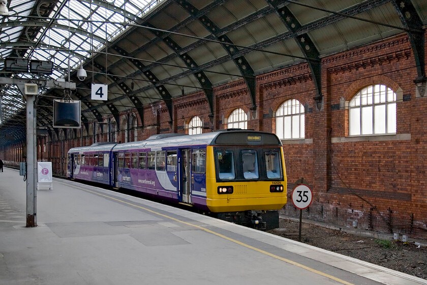 142025, NT 16.30 Saltburn-Bishop Auckland (2D41), Darlington station 
 The 16.42 Saltburn to Bishops Auckland Northern service pauses at Darlingtons platform four. The train is being worked by 142025. Darlington station remains a firm favourite of mine having a pleasant atmosphere and of a classic design that has not been ruined except for the recent installation of platform barriers. 
 Keywords: 142025 16.30 Saltburn-Bishop Auckland 2D41 Darlington station Northern Pacer