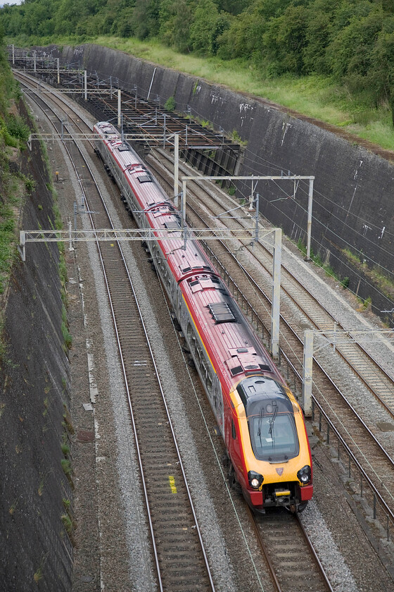 Class 221, VT 10.55 Holyhead-London Euston (1A27), Roade cutting 
 An unidentified Class 221 Voyager heads south through Roade cutting working the 10.55 Holyhead to Euston Virgin West Coast service. The 'slow' lines to and from Northampton are to the right in this photograph beginning to drop away on their descent towards the county town. 
 Keywords: Class 221 10.55 Holyhead-London Euston 1A27 Roade cutting Virgin Trains West Coast Voyager