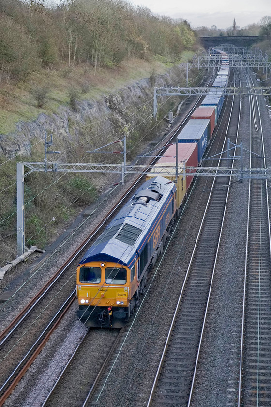 66769, 10.34 Felixstowe North-Hams Hall (4M23), Roade cutting 
 My last photograph of the day as the light fades from afternoon into the early evening. 66769 labours through Roade cutting leading the 10.34 Felixstowe North to Hams Hall Freightliner service. A short walk home from here through the village for a nice cup of tea and a toasted teacake I think! 
 Keywords: 66769 10.34 Felixstowe North-Hams Hall 4M23 Roade cutting GBRf Freightliner