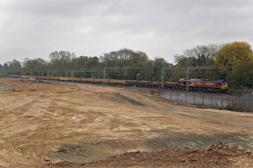 66004, 12.25 Wembley-Bescot, site of Roade station 
 66004 leads the 12.25 Wembley Yard to Bescot engineering train past the site of Roade station and the flattened and cleared Pianoforte site. This is a temporary photographic opportunity as this flattened area of land will soon be filled with a sprawling estate of modern houses with no associated services. 
 Keywords: 66004 12.25 Wembley-Bescot site of Roade station